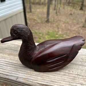 Dark Brown Ironwood carved duck measuring  6 1/2” L by 3 3/4” tall at the head.